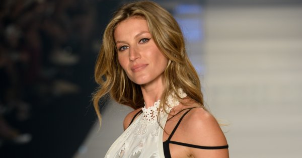 Gisele Bündchen showcases a toned figure in a crop top and mini skirt.